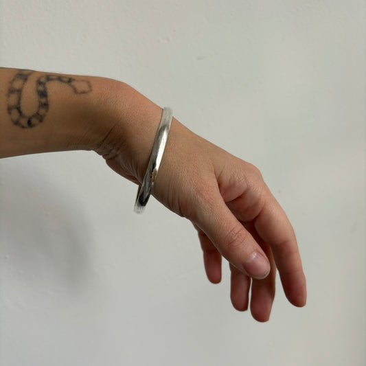 hand wearing silver bangle